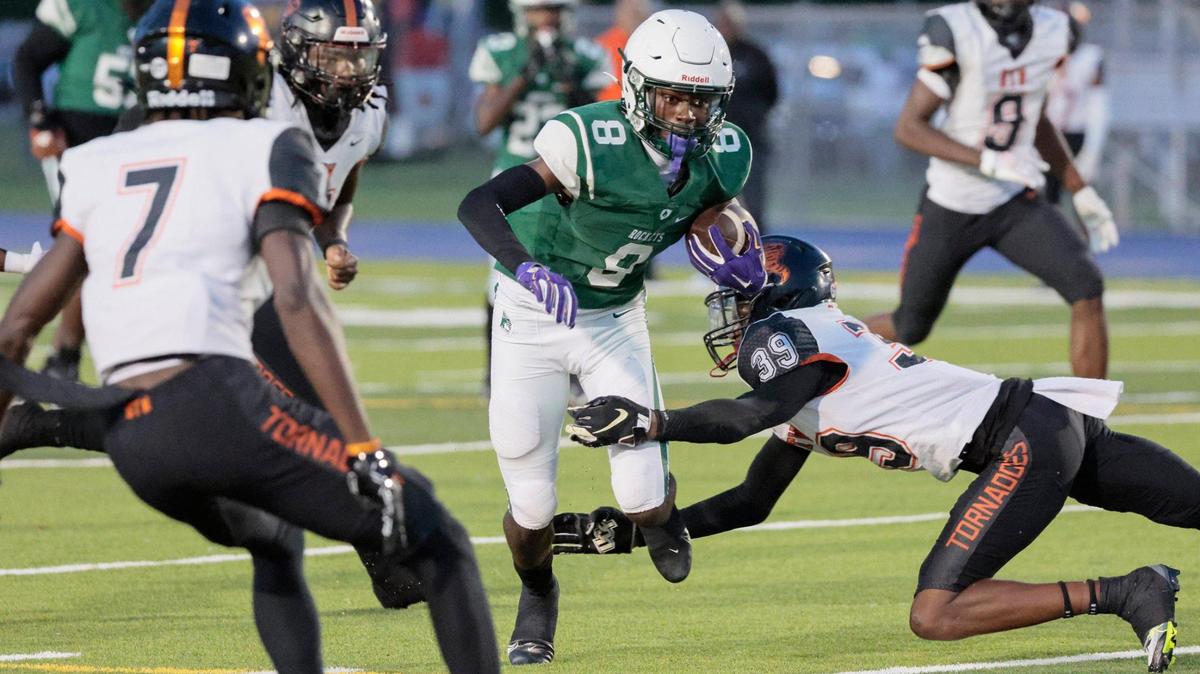 Miami Central Senior High School Rockets wide receiver Lawayne McCoy (8) on a pass reception as Booker T. Washington Senior High School defensive back Antonio Branch (39) attempts to make the stop in the first half at Traz Powell Stadium on Friday, September 9, 2022.