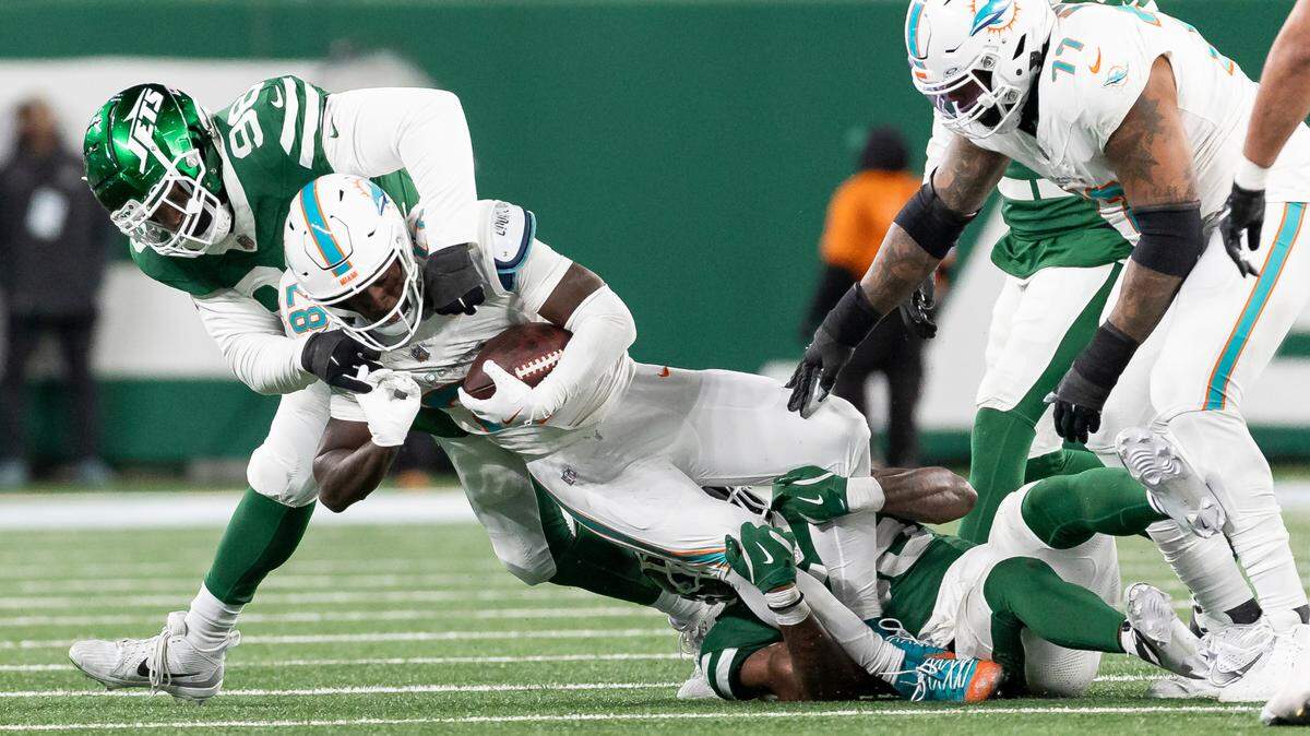 New York Jets defensive tackle Bruce Hector (98) tackles Miami Dolphins running back De’Von Achane (28) in the second half of their NFL game at the MetLife Stadium on Sunday, Jan. 5, 2025, in East Rutherford, N.J.
