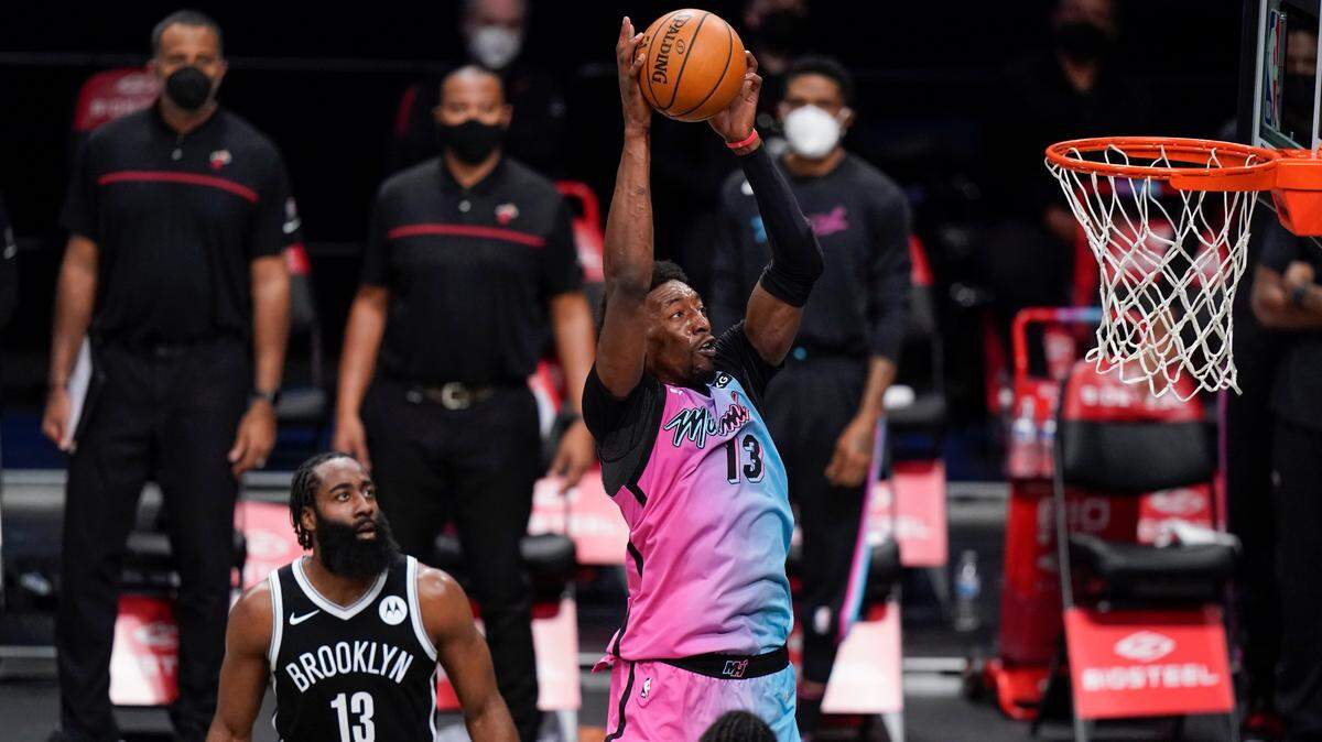 Miami Heat’s Bam Adebayo (13) drives past Brooklyn Nets’ James Harden (13) during the first half of an NBA basketball game Saturday, Jan. 23, 2021, in New York. (AP Photo/Frank Franklin II)