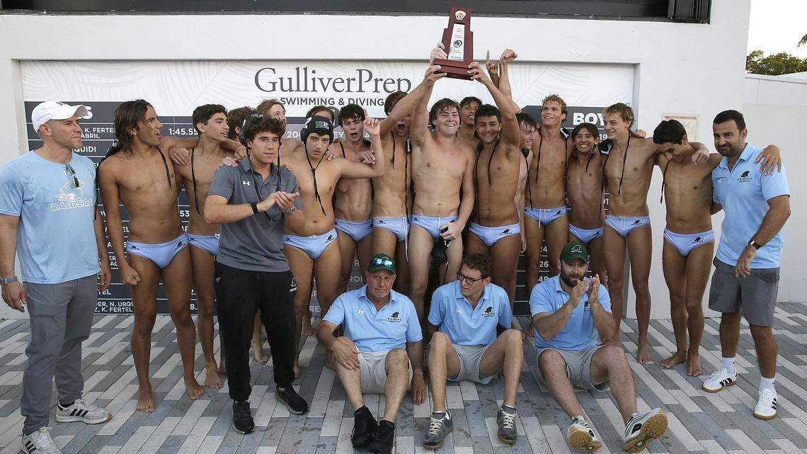 Ransom Everglade Riders pose with the trophy after winning regional boys' water polo final game against Columbus Explorers on Thursday, April 16, 2026 at Gulliver Prep HS in Miami. Andrew Uloza / for Miami Herald