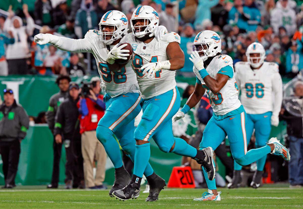 Miami Dolphins defensive tackle Raekwon Davis (98) and defensive tackle Christian Wilkins (94) react after Wilkins picks up a fumble in the first half at Lincoln Financial Field, Philadelphia, PA on Sunday, October 22, 2023.
