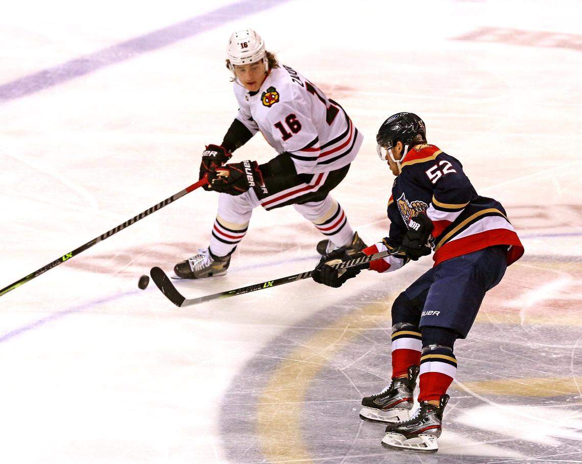 Florida Panthers MacKenzie Weegar (52) and Chicago Blackhawks Nikita Zadorov (16) in the first period at the BB&T Center in Sunrise, Florida, Saturday, March 13, 2021.