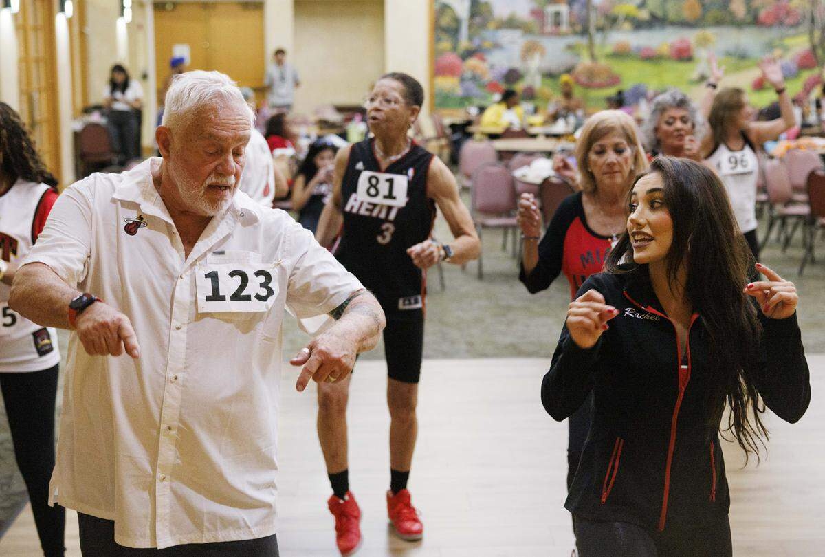 James Keith, left, works with a Miami Heat dancer to learn the routine dances during the HEAT Golden Oldies auditions for the Miami HEAT senior dance team on Thursday, Sept. 25, 2025, at Southwest Focal Point Community Center in Pembroke Pines, Fla.