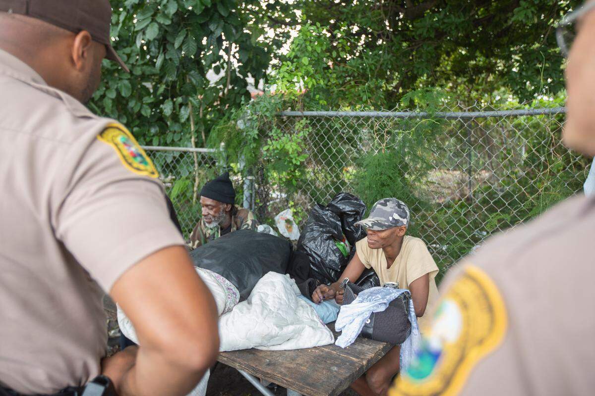 Miami-Dade officer Zuri Chambers, left, and Sergeant Jason Waite stop in Broadway Park on Friday, Dec. 28, 2018, while on patrol for Operation Blue and Brown.