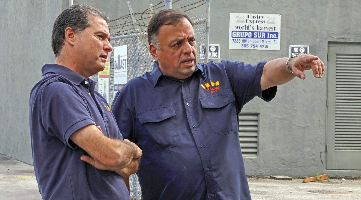 Raul Ortiz de la Renta, left, and Jose Molina, right, owners of Grupo Sur, a commercial bakery in Miami’s Little River neighborhood, were evacuated from their building in 2022 due to a report deeming it unsafe. In a lawsuit, they obtained evidence they allege shows their landlords “conspired” with an engineering firm to illegally evict them as part of a gentrification effort.Ortiz de la Renta and Molina visited the site on Thursday, June 27, 2024.
