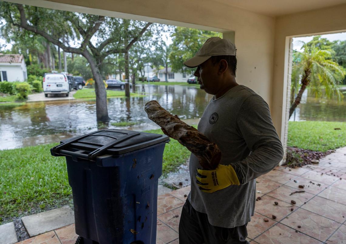 Alim Sharif, 55, cleans debris from his home on Thursday, June 13, 2024, in Hallandale Beach, Florida. Sharif’s home was inundated with 3 inches of rain after Wednesday’s storm left his community flooded by heavy rain.