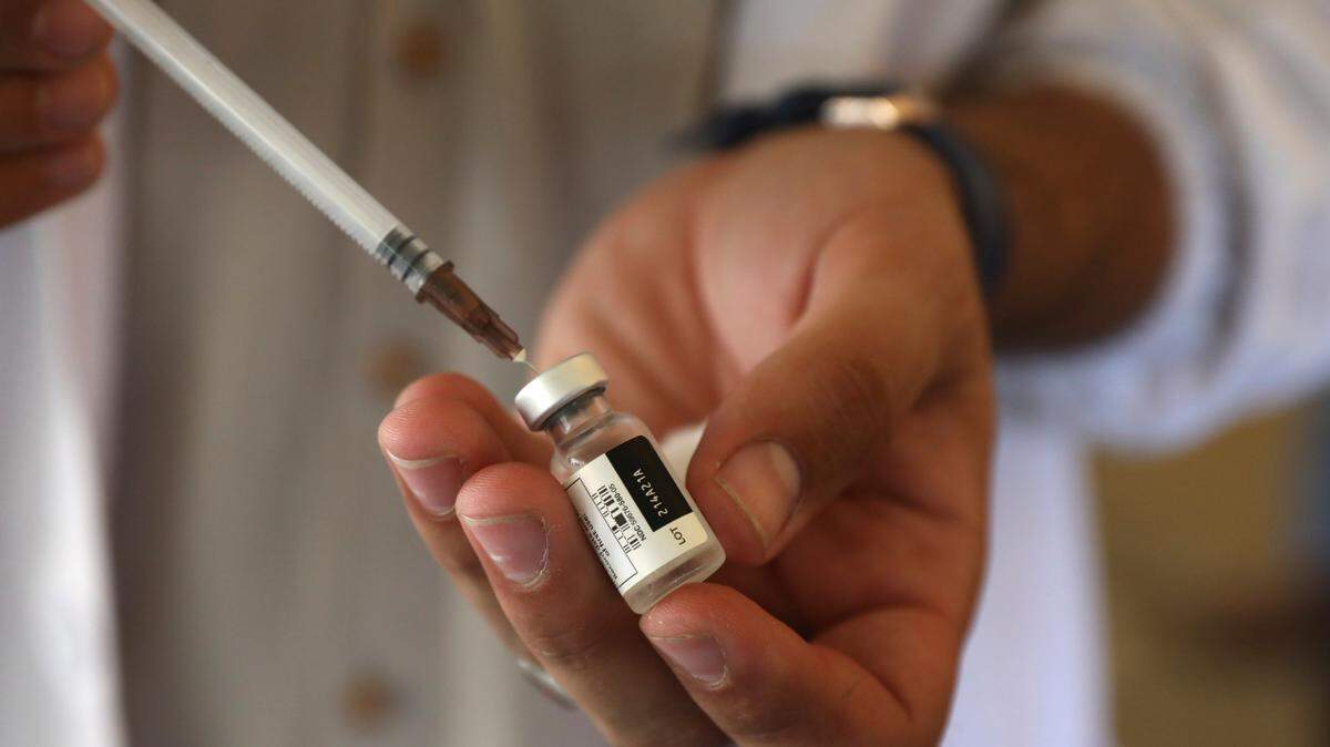 A doctor fills a syringe with the Johnson & Johnson COVID-19 vaccine at a vaccination center in Kabul, Afghanistan.