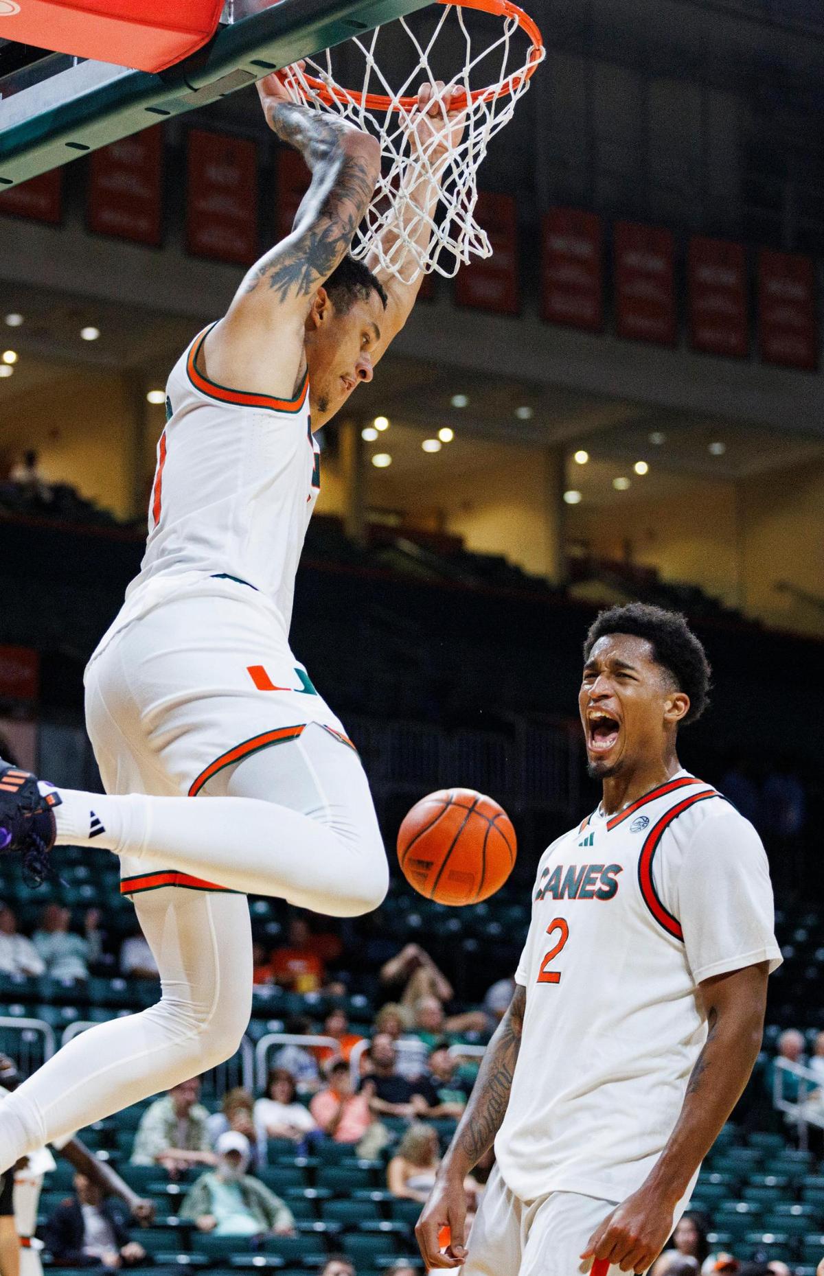 Hurricanes Lynn Kidd (1) dunks and Brandon Johnson (2) celebrates during the second half of a game against Saint Leo on Wednesday, Oct. 30, 2024, at Watsco Center at the University of Miami in Coral Gables, Fla.