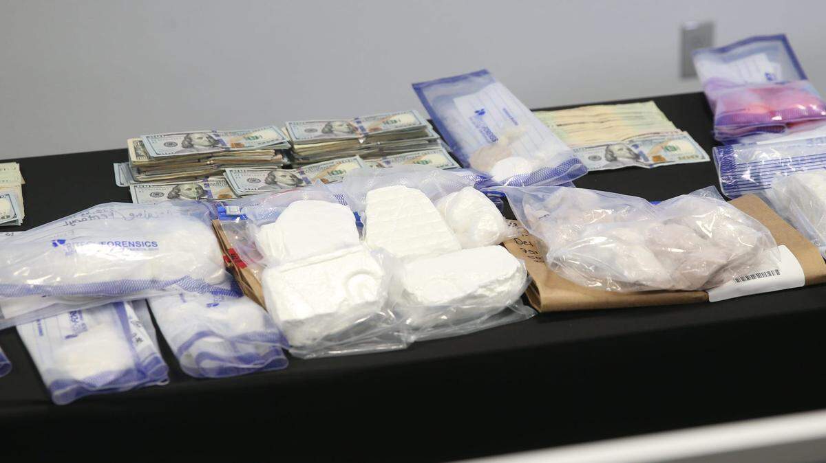 Confiscated drugs, including two pounds of fentanyl, money and guns are displayed in April at the Lee County Sheriff’s Office.