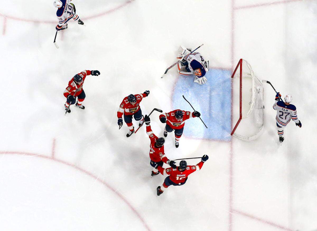 Florida Panthers center Sam Reinhart (13) celebrates with teammates after scoring his second goal of the game past Edmonton Oilers goaltender Stuart Skinner (74) during the second period of Game 6 of the Stanley Cup Final at Amerant Bank Arena on Tuesday, June 17, 2025, in Sunrise, Fla.