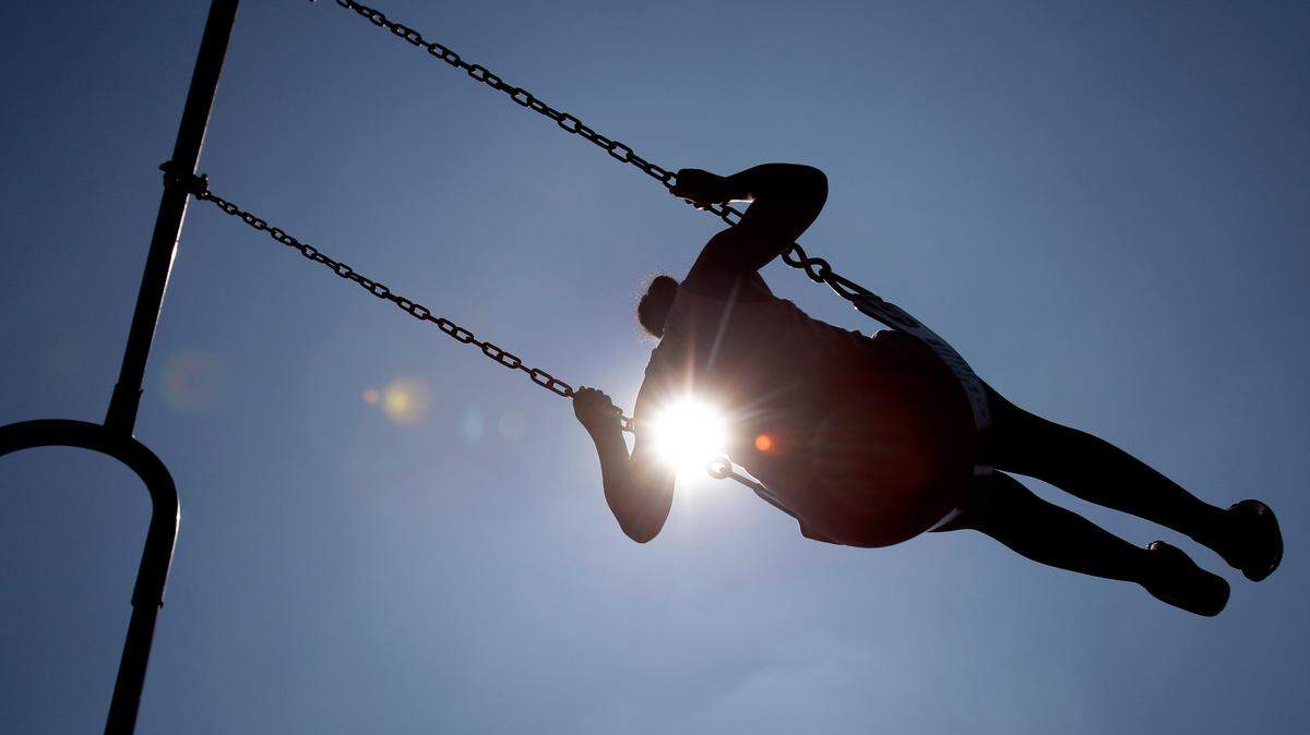 Keshawna Hill, 8, swings as the afternoon sun beats down Thursday, July 21, 2011, in St. Louis.