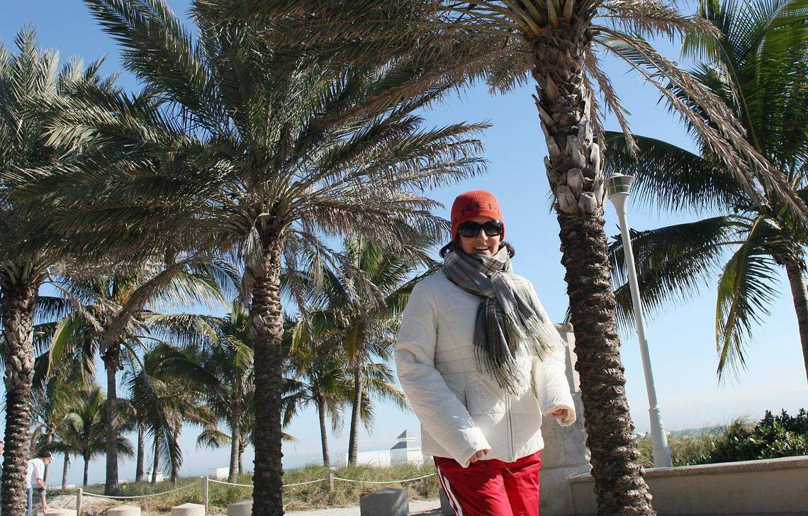 In this file photo from Jan. 10, 2010, in Miami Beach, a runner bundles up as she excises on the boardwalk next to the beach when it was 36 degrees in Miami in the morning. At the time, that beat an 82-year-old record of 37 degrees.