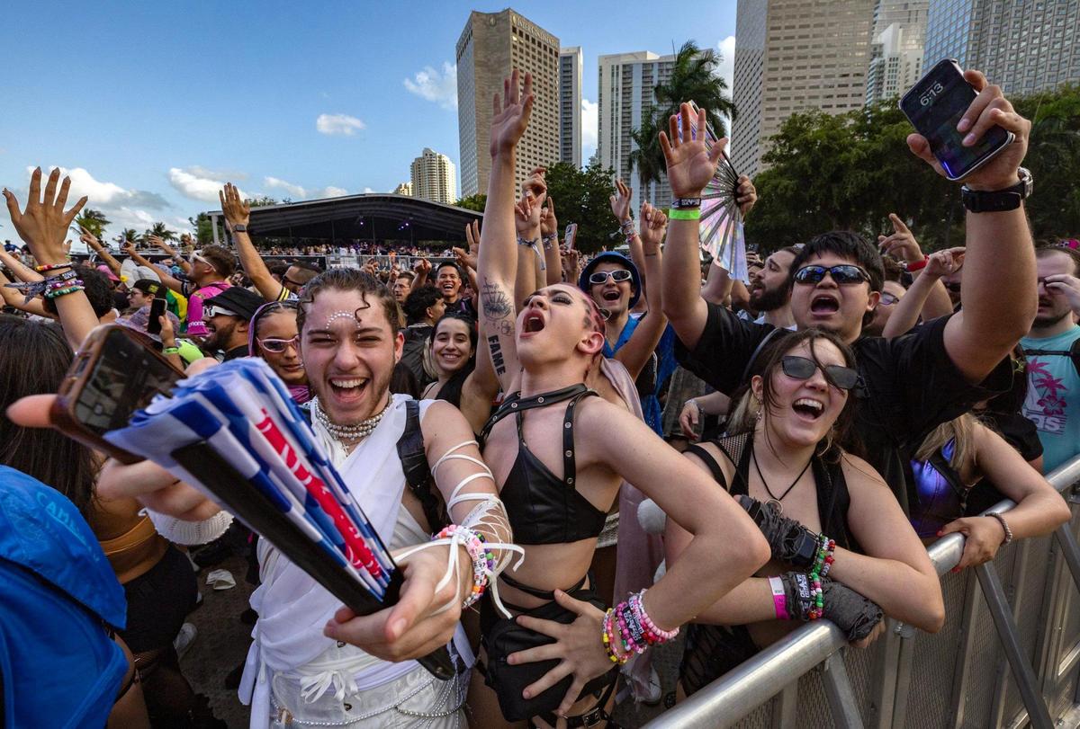 Gavin Grabarnick, at left, and Mason Leon, at center, dance during Ultra Music Festival’s 25th anniversary at Bayfront Park, in Miami, Florida, on Friday, March 28, 2025.