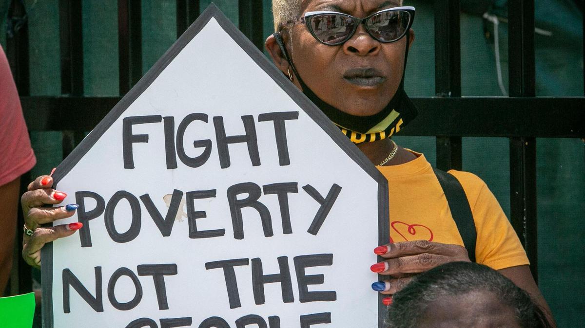 Frederica Dawson holds a sign in protest during a demonstration in Allapattah on June 8, 2021, against evictions.