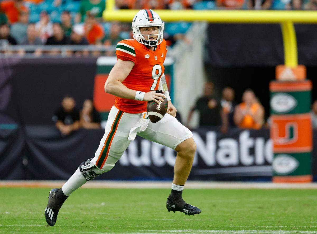 Miami Hurricanes quarterback Tyler Van Dyke (9) scrambles in the second half against the Virginia Cavaliers at Hard Rock Stadium in Miami Gardens on Saturday, October 28, 2023.