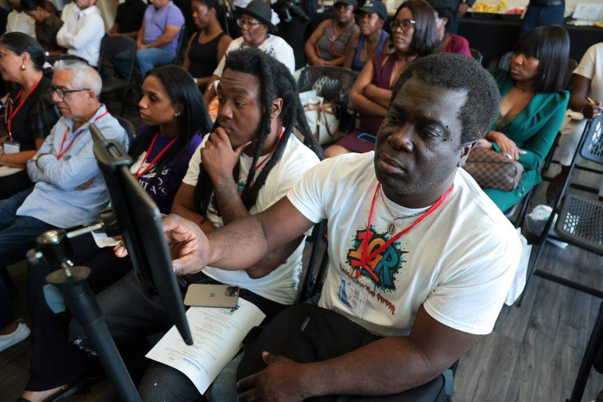 Bazile Bourdeau, right, a business partner with 1GR Urbanwear CEO and owner, Jovany Appolon, left, take notes on a tablet during a panel discussion at the City of North Miami District 4 Small Business Expo at the Joe Celestin Center at 1525 NW 135th St. in North Miami, Florida, Friday, August 22, 2025.