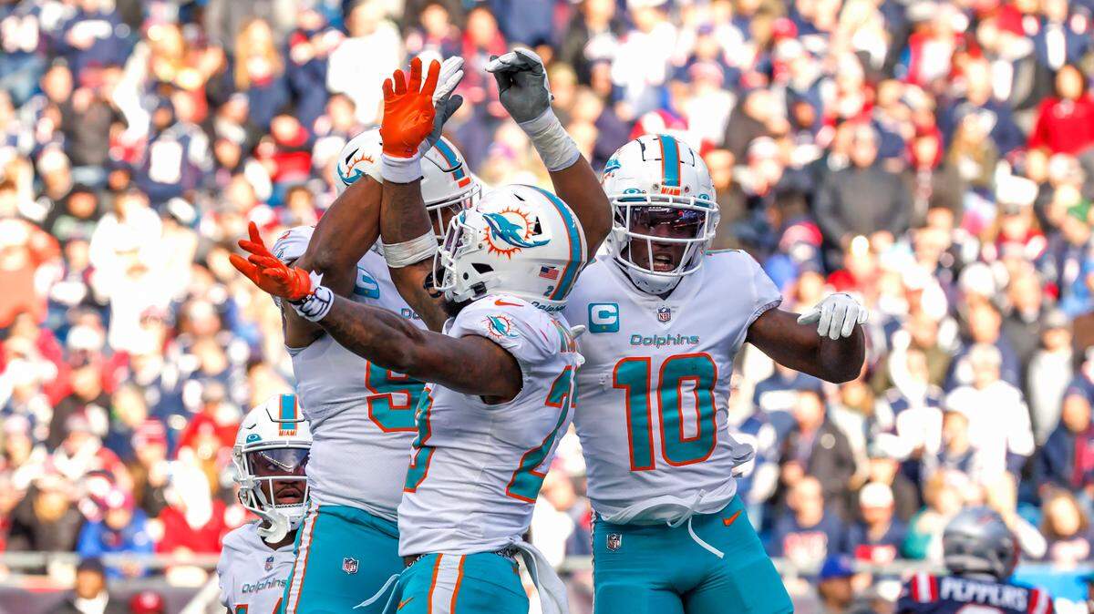 Miami Dolphins wide receiver Tyreek Hill (10) celebrates with teammates after scoring a touchdown during second quarter of an NFL football game against the New England Patriots at Gillette Stadium on Sunday, January 1, 2023 in Foxborough, MA.