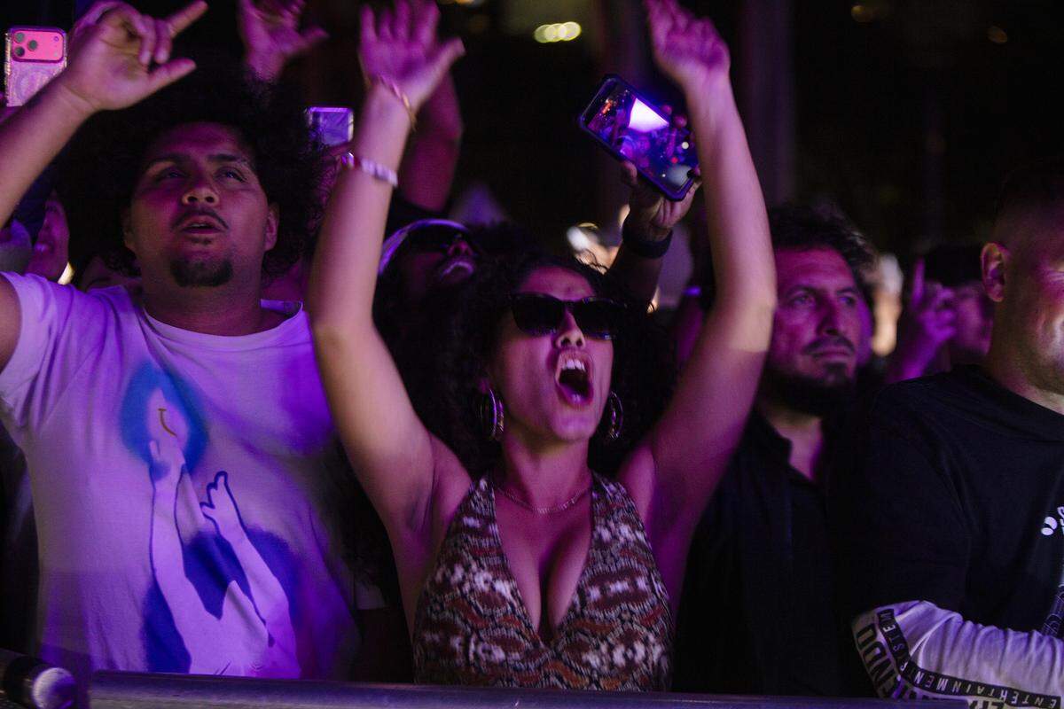 People react to music during New Year’s Eve celebrations at Bayfront Park in Miami.