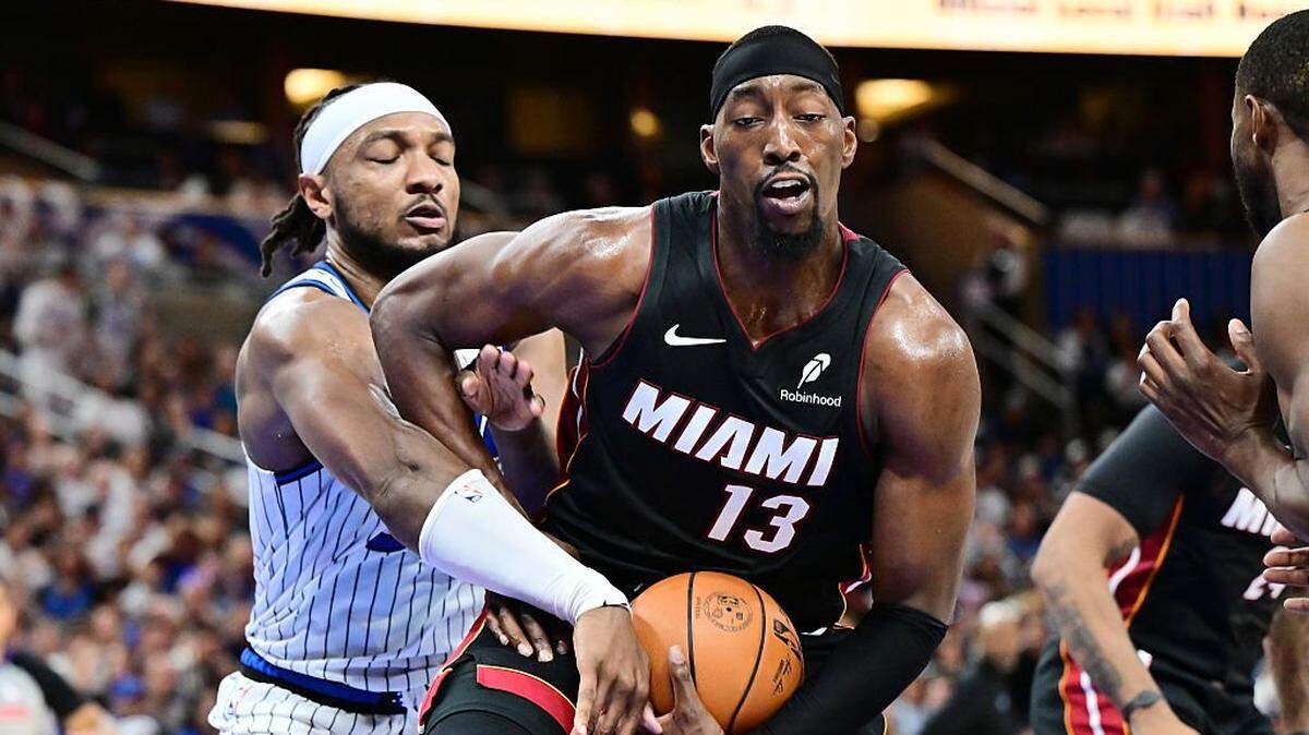 ORLANDO, FLORIDA - OCTOBER 22: Bam Adebayo #13 of the Miami Heat grabs a defensive rebound against Wendell Carter Jr. #34 of the Orlando Magic in the second half of the game at Kia Center on October 22, 2025 in Orlando, Florida. NOTE TO USER: User expressly acknowledges and agrees that, by downloading and or using this photograph, User is consenting to the terms and conditions of the Getty Images License Agreement. (Photo by Julio Aguilar/Getty Images)