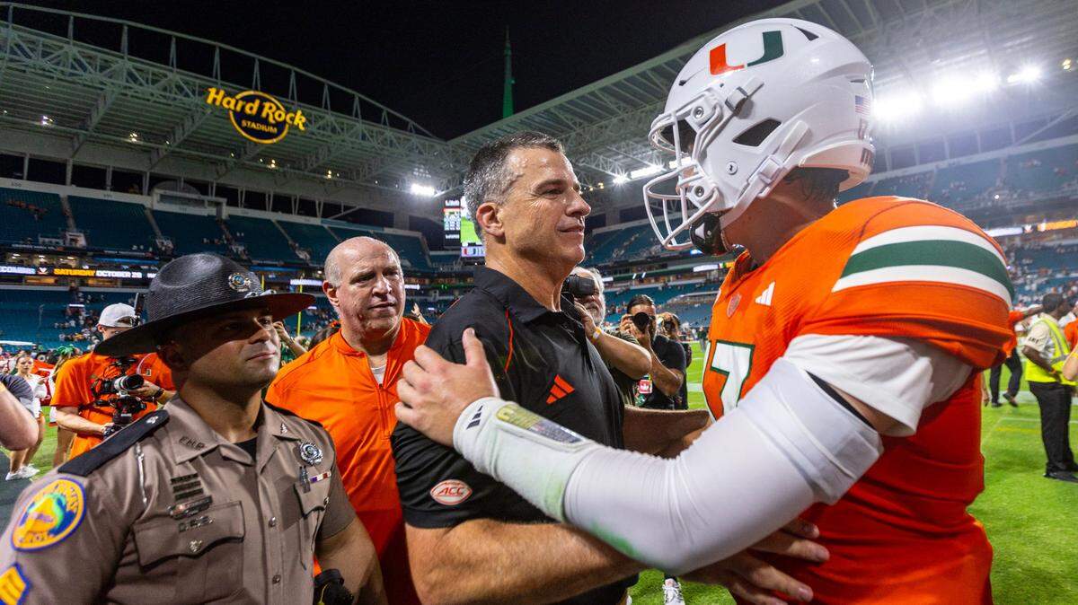 University of Miami Head Coach Mario Cristobal reacts with quarterback Emory Williams (17) after defeating Clemson 28-20 in double overtime during an ACC college football game at Hard Rock Stadium in Miami Gardens, Florida, on Saturday, October 21, 2023. 