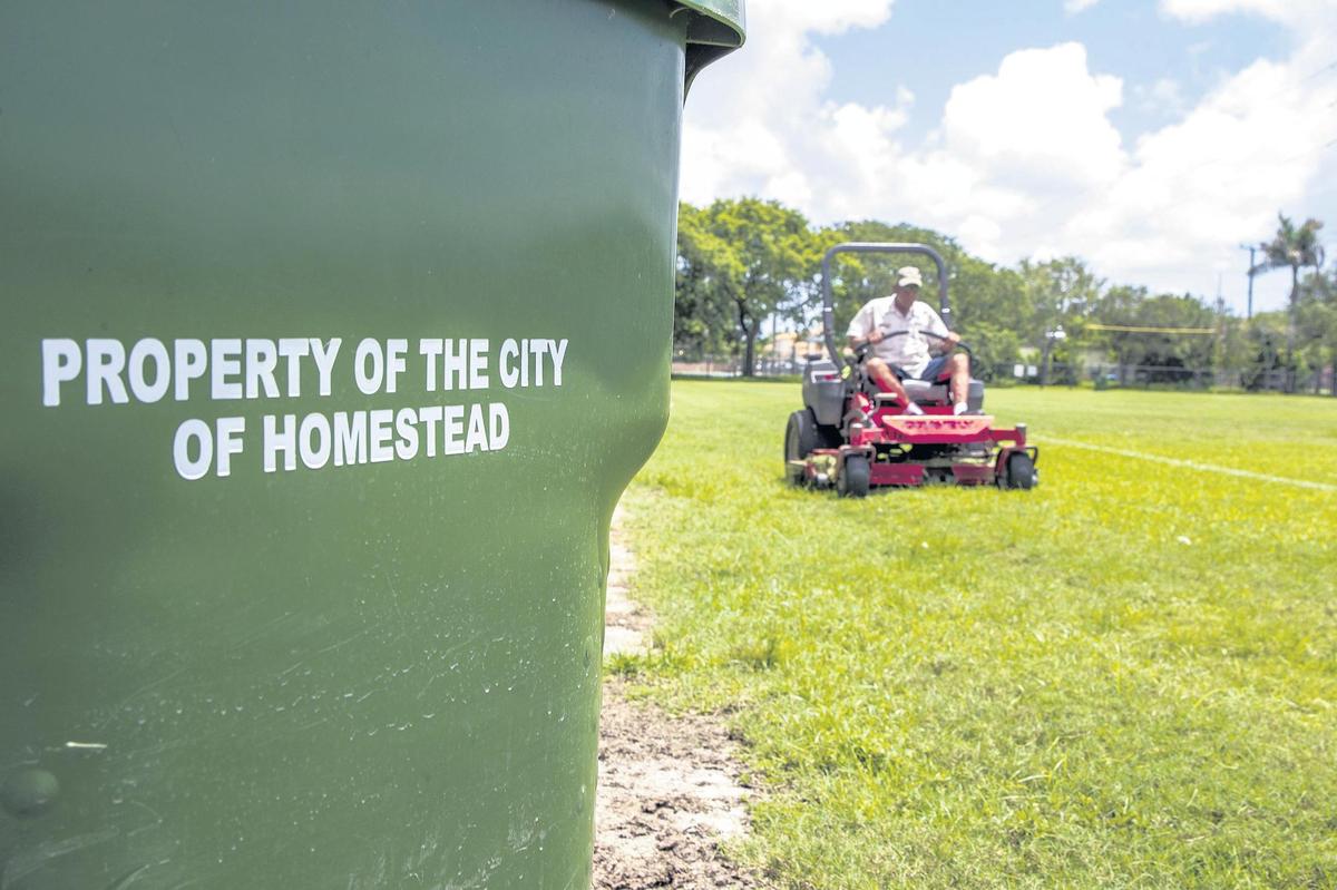 Public Works employee Alfonso Morales mows the grass in the soccer field at Harris Field in Homestead.
