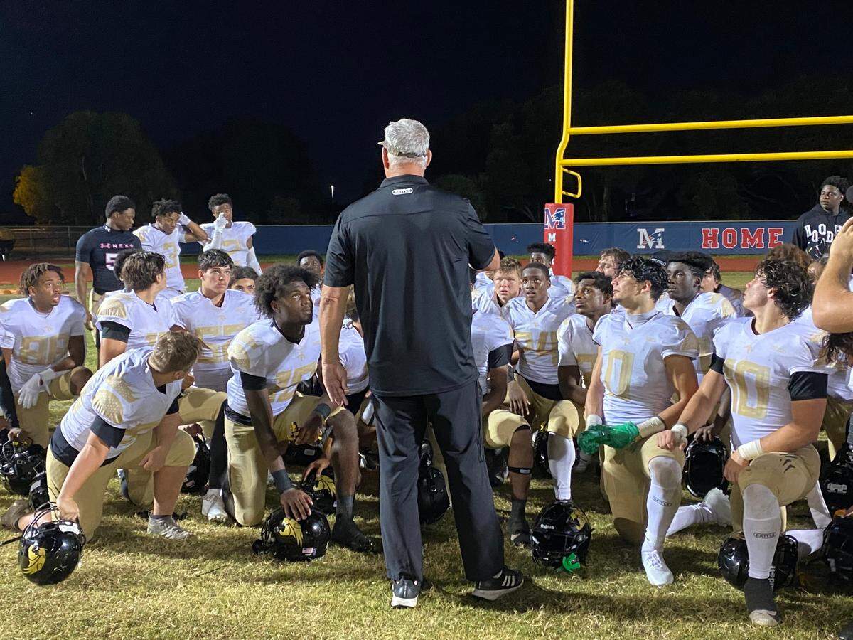 Western football coach Adam Ratkevich speaks to his team after the Wildcats beat Miramar 14-6 on Friday night at Miramar High.