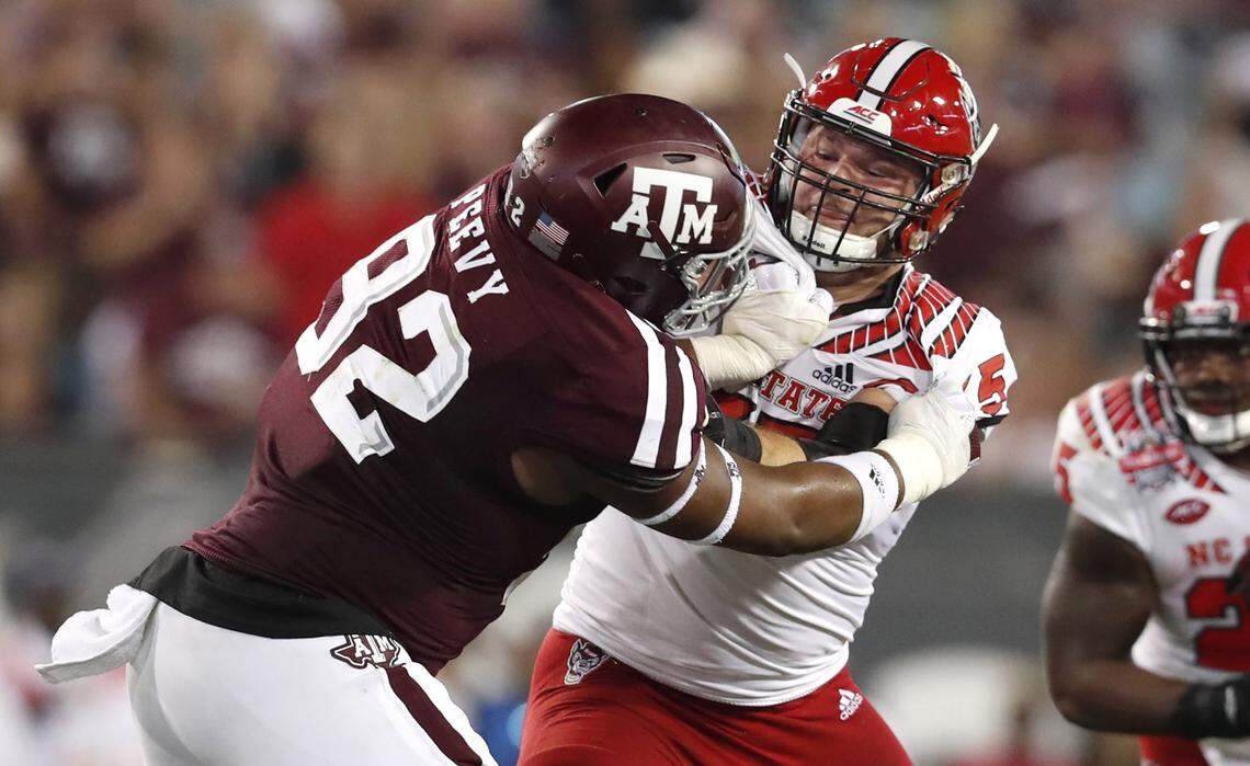 N.C. State center Garrett Bradbury (65) blocks Texas A&M defensive lineman Jayden Peevy (92) during the first half of N.C. State’s game against Texas A&M in the TaxSlayer Gator Bowl at TIAA Bank Field in Jacksonville, Fla., Monday, Dec. 31, 2018.