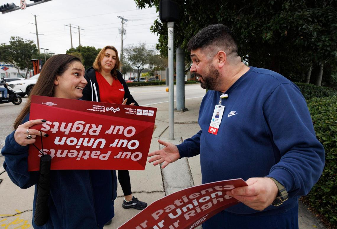 Lazaro Garcia, union representative for Palmetto, right, speaks to member Barbara about upcoming union ideas after a nurses protest outside of Palmetto General Hospital for better workplace conditions on Thursday, Jan. 16, 2025, outside of Palmetto General Hospital in Hialeah, Fla. “We wanted to show our power as a unit as a way to stand up for patient safety [regarding] safe staffing levels and equipment,” said Garcia.