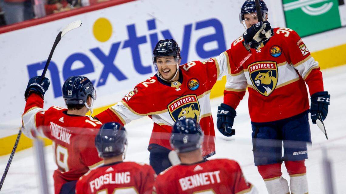 Florida Panthers players swarm left wing Matthew Tkachuk (19) after he scored on Tampa bay Lightning goalie Andrei Vasilevskiy (88) during the first period of an NHL game at FLA Live Arena in Sunrise, Florida, on Friday, October 21, 2022.