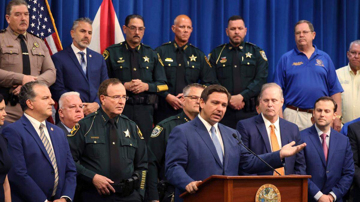 Gov. Ron DeSantis at a news conference at the Polk County Sheriff’s Office in Winter Haven on April 19, surrounded by law enforcement, legislators, and police union representatives.