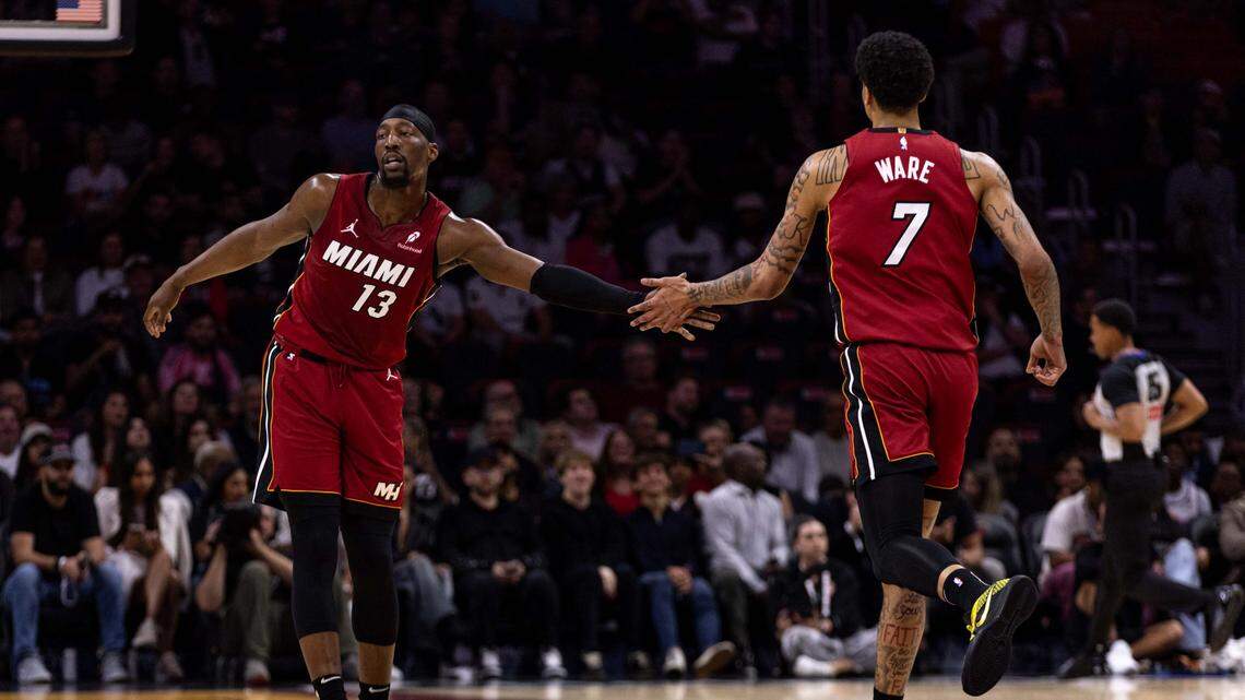 Miami Heat center Bam Adebayo (13) daps up center Kel'el Ware (7) during the first half of an NBA game against the Atlanta Hawks on February 26, 2025, in Miami.