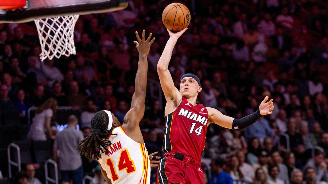 Miami Heat guard Tyler Herro (14) floats the ball over Atlanta Hawks guard Terance Mann (14) during the second half of an NBA game on Wednesday, February 26, 2025, in Miami, Florida.