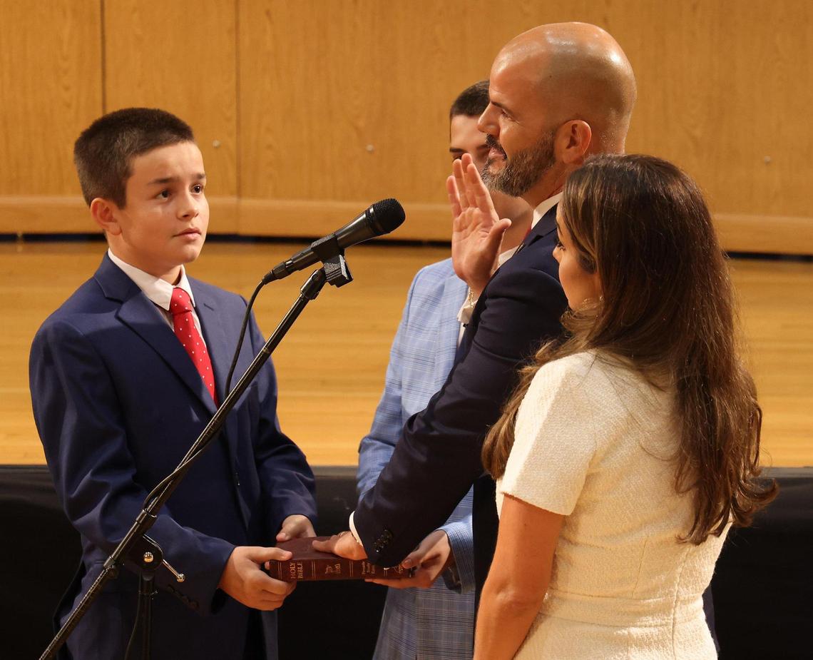 Standing with his wife Alexandra Alonso, right, and sons Oliver and Robert Alonso, newly elected Miami-Dade School Board member Roberto Alonso places his hand on the Bible. On Tuesday, Nov. 15, 2022, Lt. Gov. Jeanette Nuñez conducted a ceremonial swearing in of the two newly elected board members inside Miami-Dade School District building in Miami, Florida, Alonso and Monica Colucci. They will both be officially sworn in on Tuesday, Nov. 22, 2022.