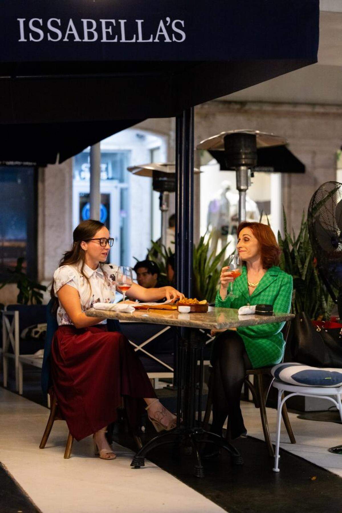 Krystal Millie Valdez and Irene Adjan in a scene at Issabella’s on Lincoln Road in Miami New Drama’s “Lincoln Road Hustle.”