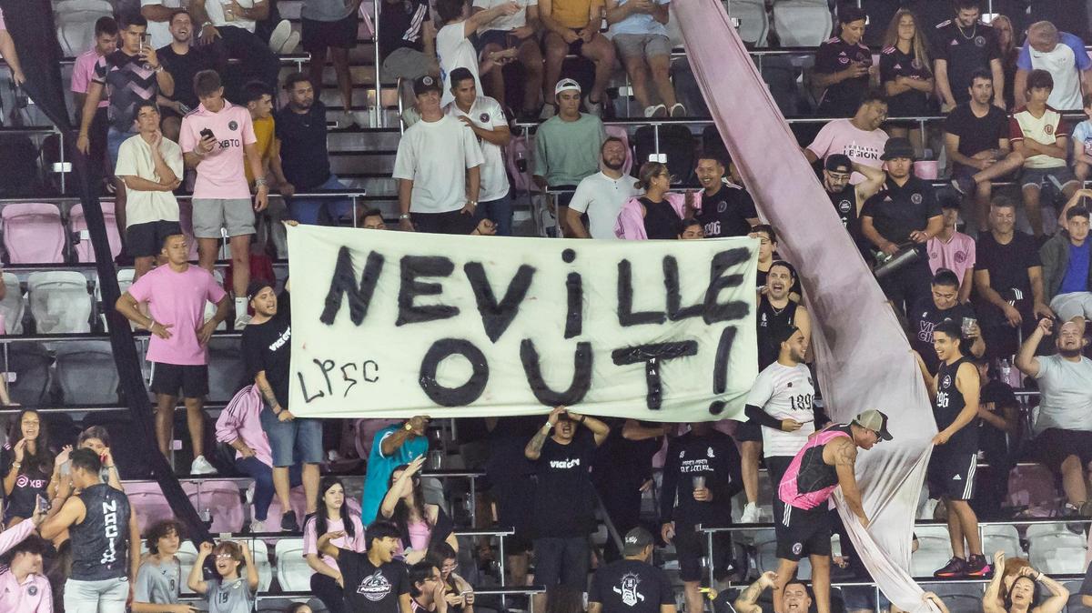 Inter Miami fans hold a sign that reads ‘Neville Out’ as their team play against the New York Red Bulls in the second half of an MLS game at DRV PNK Stadium on Wednesday, May 31, 2023, in Fort Lauderdale, Fla.