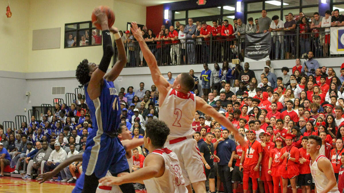 Dillard’s Jalen Haynes puts a shot up over Doral’s Jonathan Nunez during the Panthers 41-29 win on Friday night bringing and end to Doral’s record 50-game winning streak.