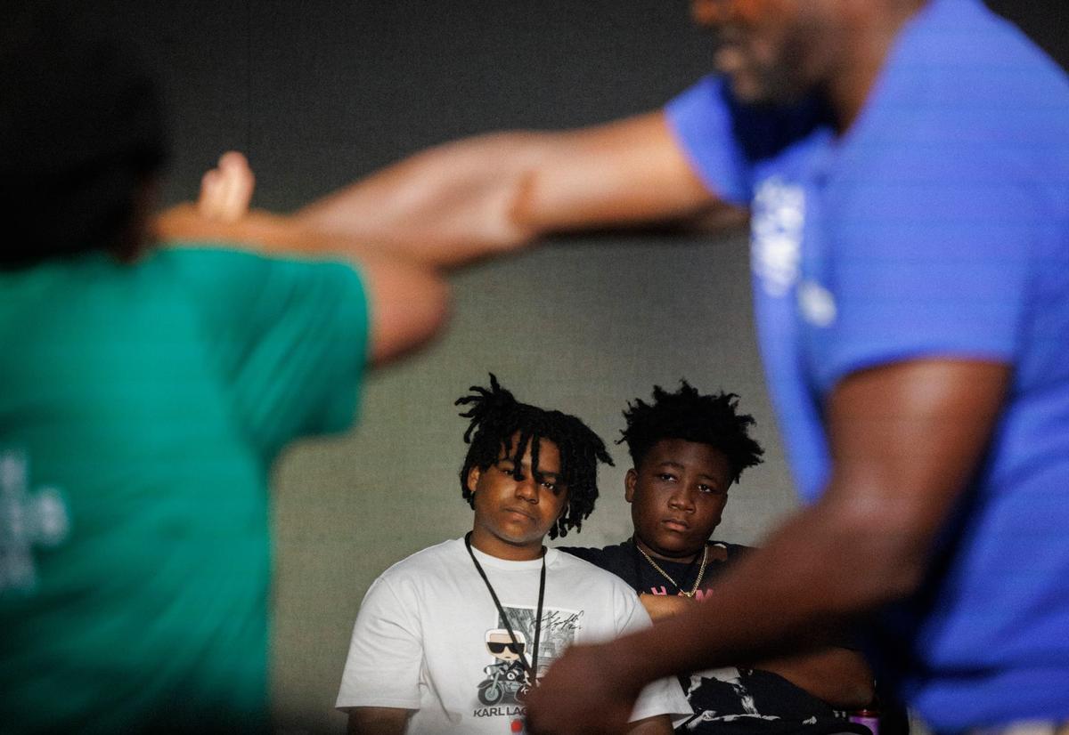D’Mari Mays, left, and Kesley Mondesir, right, watch Kimberly Muhammad teach a self defense class during the Dream Defenders’ Peace Summit camp for kids and teenagers on Thursday, June 20, 2024 at Sandrell Rivers Theater in Miami.