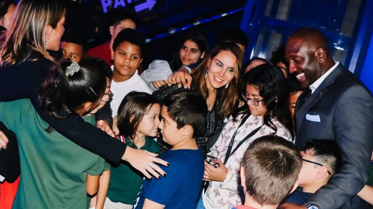 Children from Big Brothers Big Sisters of Miami at a recent “All in for Smiles” day of fun event surround Leila Centner, co-founder of the David and Leila Centner Family Foundation.
