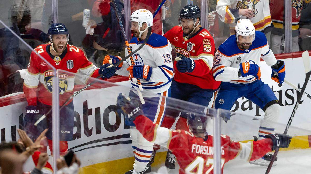 Florida Panthers center Carter Verhaeghe (23) celebrates with teammate Aleksander Barkov (16) and Gustav Forsling (42) after scoring against the Edmonton Oilers during the first period of Game 1 of the NHL Stanley Cup Final at the Amerant Bank Arena on Saturday, June 8, 2024, in Sunrise, Fla.