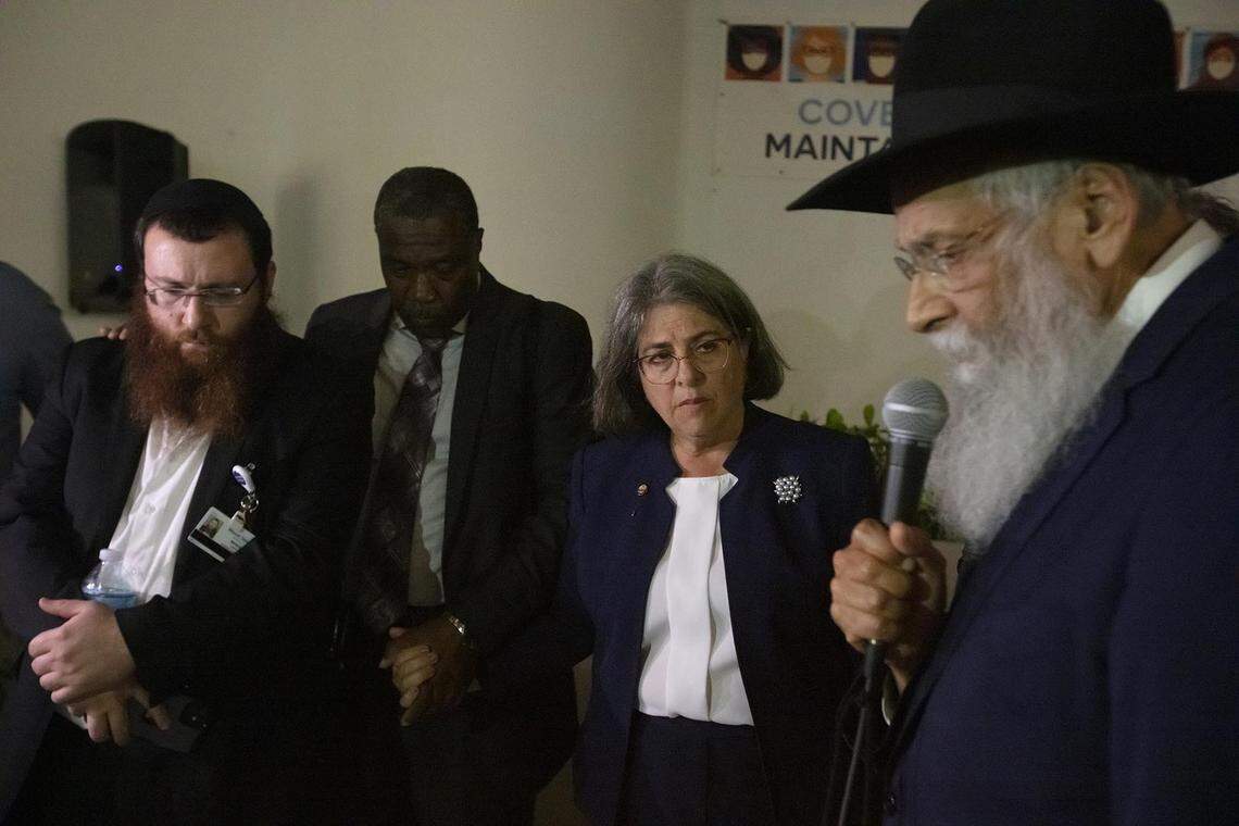 Rabbi Sholom Lipskar, right, leader of The Shul of Bal Harbour, prays during the search-and-rescue operation after the partial collapse of the Champlain Towers South in Surfside on Thursday June 24th., 2021.