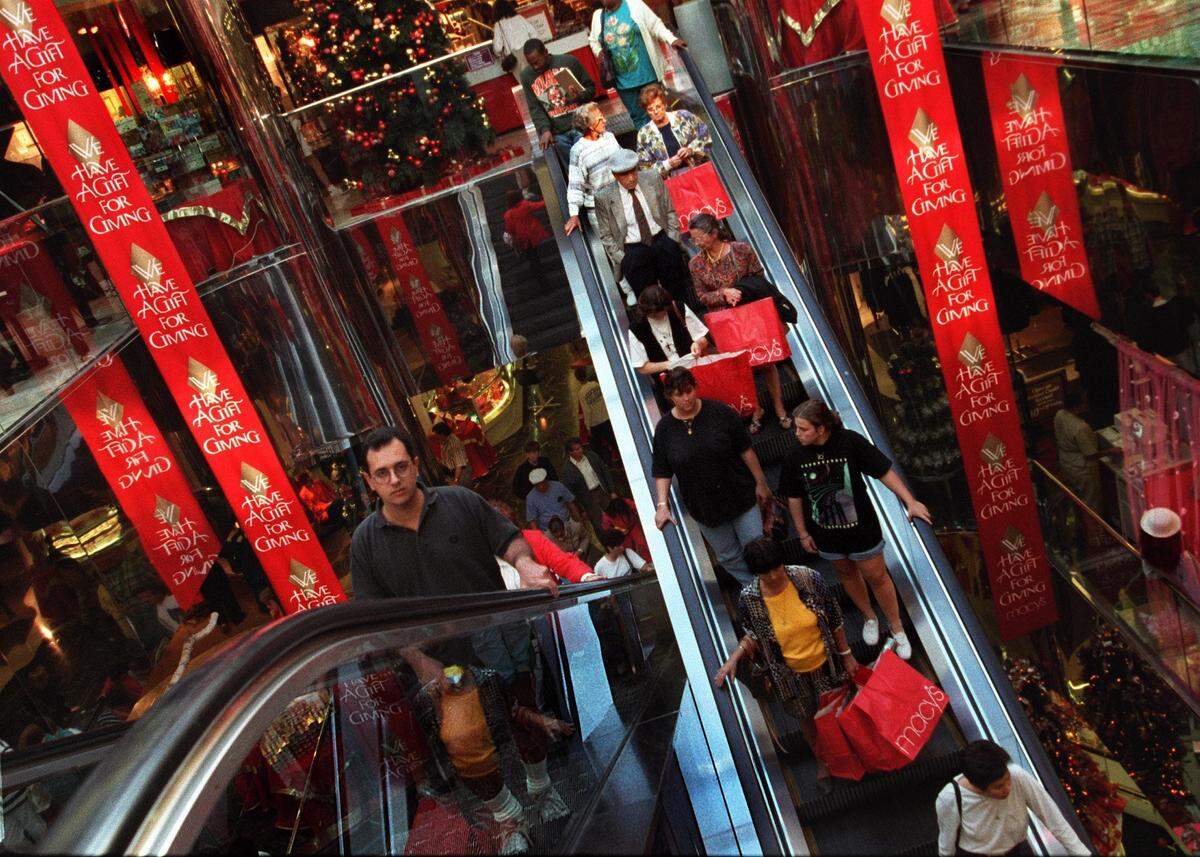In December 1994, Alex Perez, left, plans out Christmas shopping at Macy’s at the Aventura Mall.