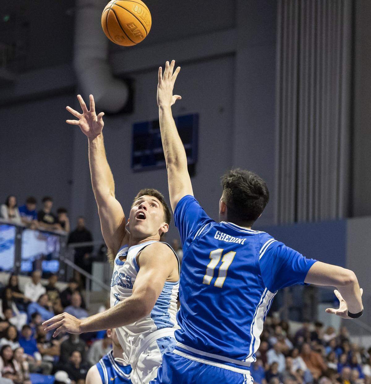 Nova Southeastern Sharks guard Ryan Davis (1) shoots the ball as Rollins Tars guard Ricky Ghedini (11) defends in the first half of their Sunshine State Conference Championship quarterfinal basketball game at the Rick Case Arena on Tuesday, March 3, 2026, in Davie, Fla.