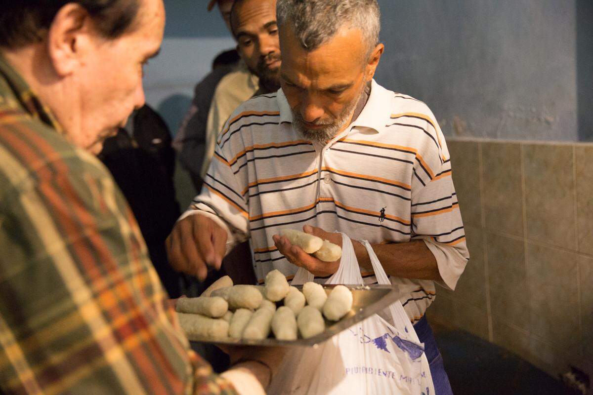 When Casa de Maria runs out of soup, Benito Prieto serves bollitos, cooked corn flour dough.  “The idea is that no one leaves without something in their belly. And hopefully tomorrow they will get soup,” he says.