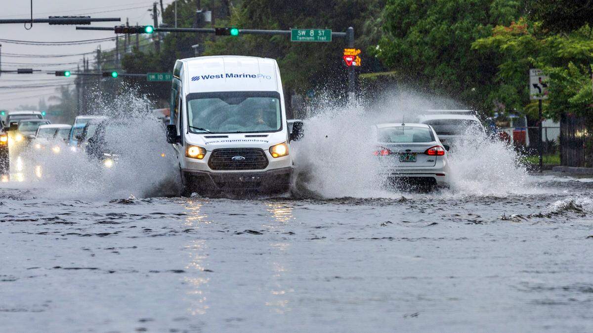 Commuters drive through flooded Southwest 67th Avenue in Miami as heavy and torrential downpours from strong thunderstorms swept through South Florida on Tuesday, Sept. 9, 2025.