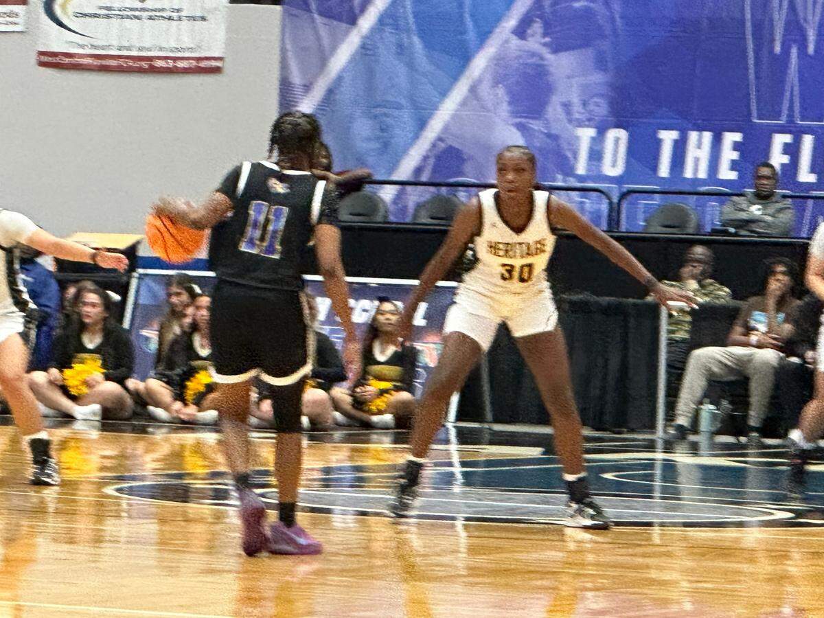 American Heritage forward Dezuray McGill prepares to defend Rickards guard Genesis Henry during Tuesday’s girls’ basketball Class 4A state semifinal at the RP Funding Center in Lakeland, Fla.