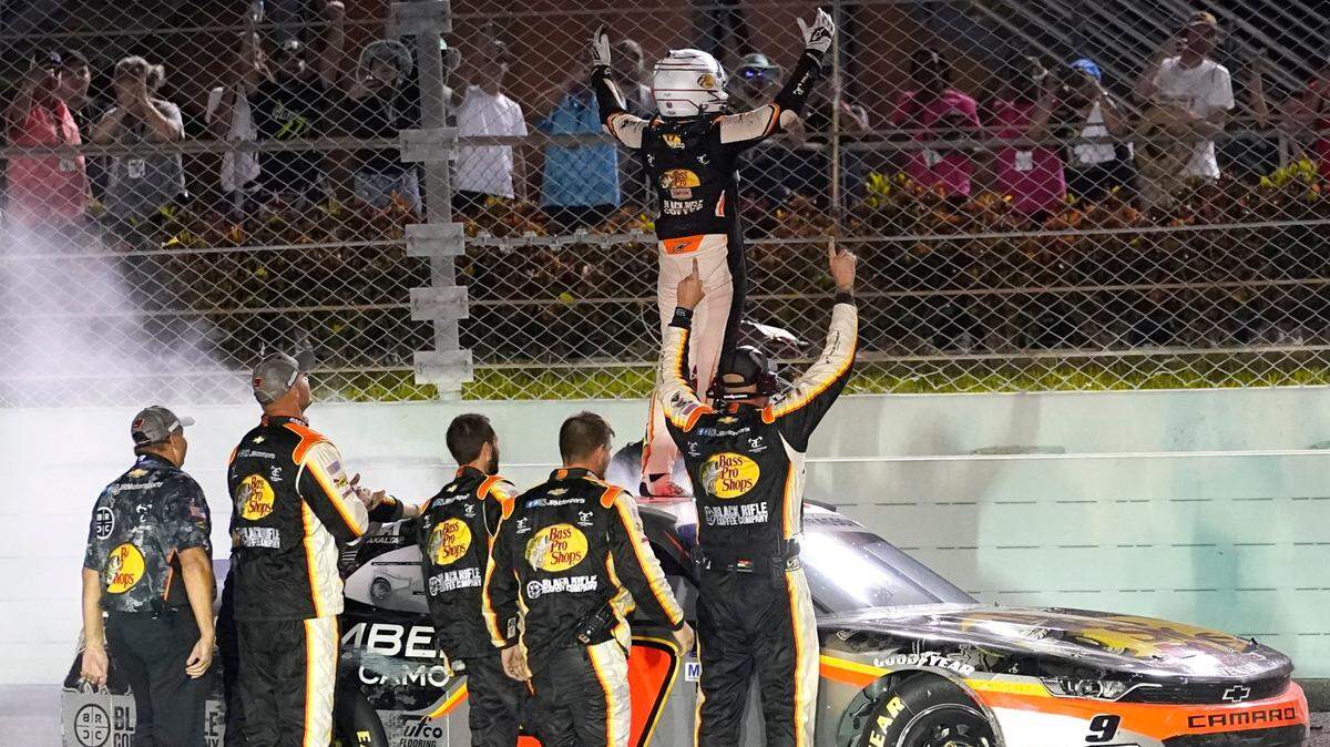 Noah Gragson celebrates on the roof of his car after winning the NASCAR Xfinity Series auto race at Homestead-Miami Speedway, Saturday, Oct. 22, 2022, in Homestead, Fla. (AP Photo/Lynne Sladky)