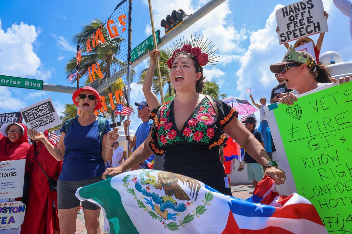 Diana Montes, 32, center, a dual citizen of Mexico and United States, waves a flag bearing both nations as she joins in a No Kings protest on A1A and Sunrise Boulevard in Fort Lauderdale on June 14, 2025. At its peak between 400-500 protesters gathered at the Fort Lauderdale event. The rally was just one of thousands held across the country on the birthday of President Trump.