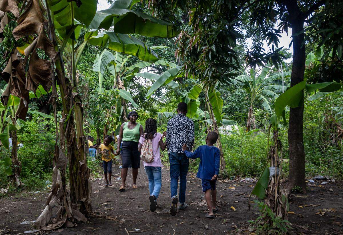 People go about their day at a displacement camp in Leogane, about 20 miles west of Port-au-Prince. The camp shelters Haitians who have been forced to flee their homes by gang violence.