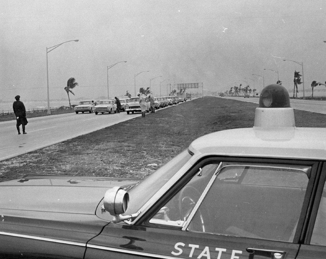 Florida Highway Patrol troopers stop cars on the Julia Tuttle Causeway during Hurricane Betsy in 1965.