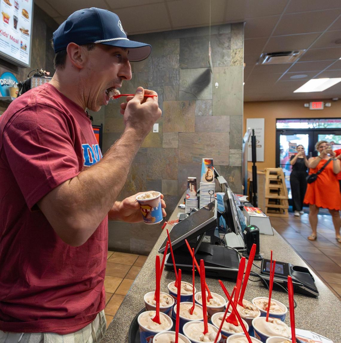 Florida Panthers center Brad Marchand enjoys his signature menu item, the ‘Brad Bizard,’ during a surprise visit with fans at Dairy Queen in Sunrise, Florida, on Friday, June 20, 2025, in celebration of the team’s Stanley Cup victory.